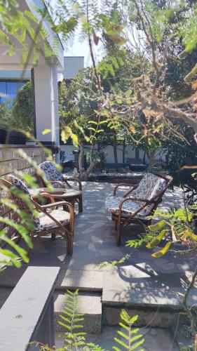 a group of benches sitting on a patio at Villa Pagar - with jacuzzi - Renovated in 2022 in Povljana