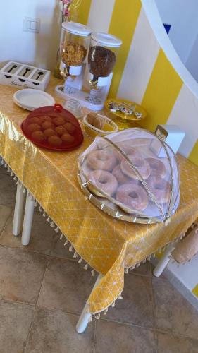 a table with a plate of food on it at B&B Dimora del centro in Scalea