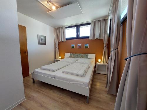 a bedroom with a white bed and a window at Mira in Winterberg