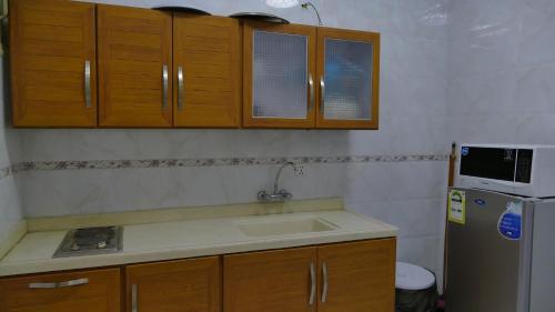 a kitchen with a sink and a refrigerator at ABHASKY in Abha