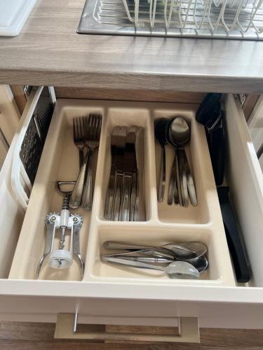 a drawer in a refrigerator filled with utensils at Oakley Newquay Bay Resorts in Newquay Bay Resort