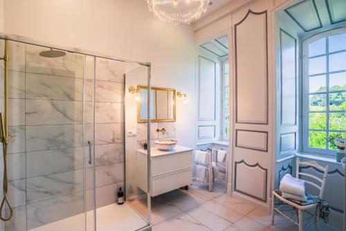 a bathroom with a glass shower stall and a sink at Château de La Vigne in Ally