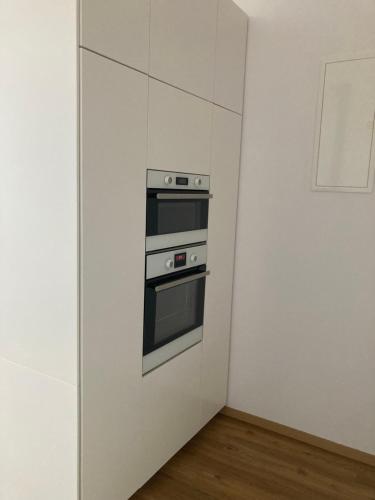 a kitchen with a stove in a white wall at Dům U Lipky in Světlá nad Sázavou