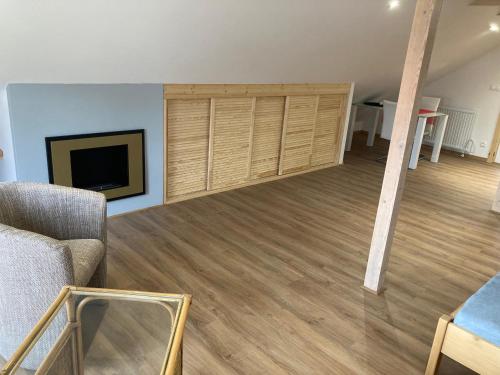 a living room with a couch and a flat screen tv at Dům U Lipky in Světlá nad Sázavou