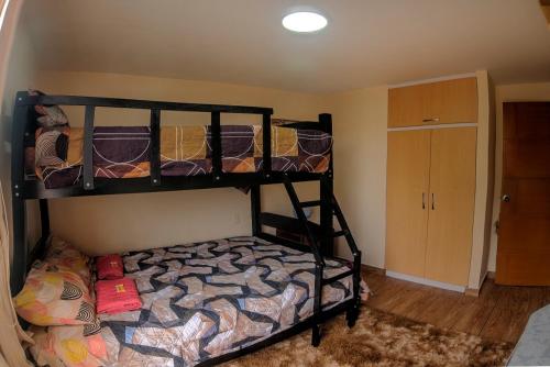 a bedroom with two bunk beds in a room at Dpto entero, 2do piso, ascensor, jacuzzi y cochera in Lima