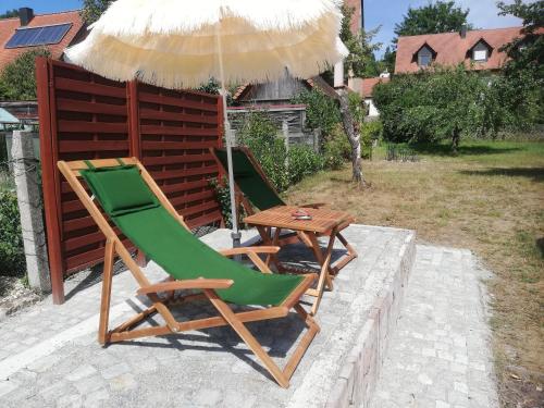 two chairs and a table under an umbrella at Ochsenhof in Feuchtwangen