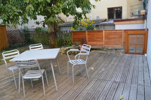 a table and chairs on a wooden deck at Résidence des Thermes in Allevard