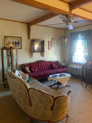 a living room with a couch and a table at Tombstone Bordello Bed & Breakfast in Tombstone