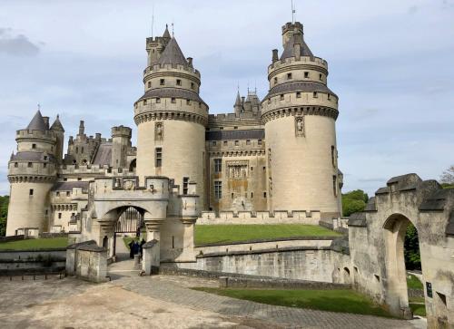 a castle with two towers on top of it at gîte Cosy Green 2 in Chevincourt