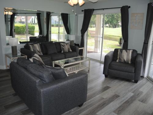 a living room with two couches and two chairs at 503 villa in Calabash