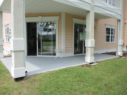 a front porch of a house with glass doors at 503 villa in Calabash