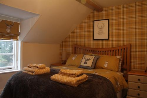 a bedroom with a bed with two pillows on it at West View Cottage in Worcester