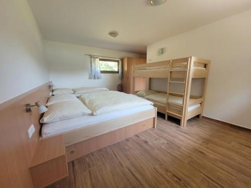 a bedroom with a bunk bed and a book shelf at Chaty u Tesaru in Bítov