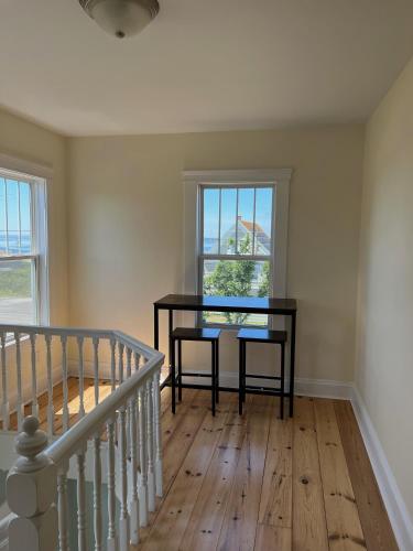 a dining room with a table and a window at Breakwater Lodge in Lower Woods Harbour