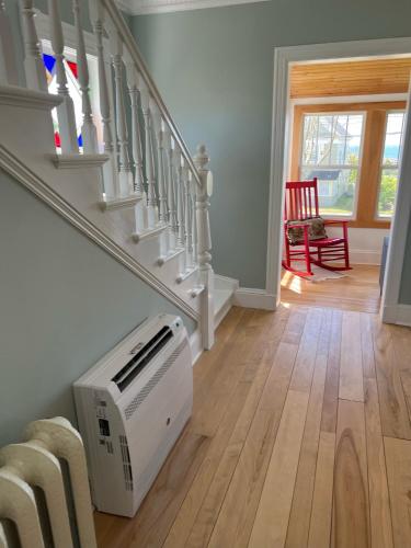 a room with a staircase with a toaster under the stairs at Breakwater Lodge in Lower Woods Harbour