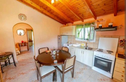 a kitchen with a wooden table and a dining room at TETRAKTYS ESTATE ( ΑΗΡ ) in Halikounas