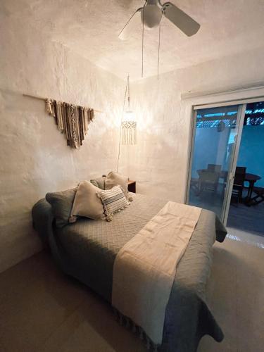 a bedroom with a bed with a ceiling fan at Hermoso condominio con alberca y club de playa!! in Manzanillo