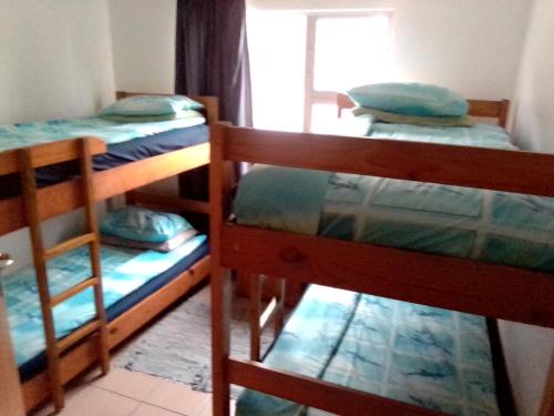 a room with three bunk beds and a window at Peacefull Memories in Cintsa Mouth West