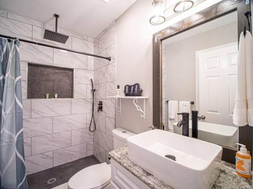een witte badkamer met een wastafel en een toilet bij Homey Bungalow Convenient to Marietta and I-75! in Marietta