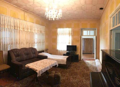 a living room with a couch and a television at Haer B&B in Meghri