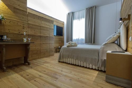 a bedroom with a bed and a wooden wall at BIO & B - ITALYKE in Viterbo