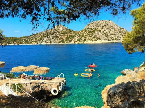 a view of a beach with people in the water at Victory's house, 3min walk to Skala's sandy beach in Skala