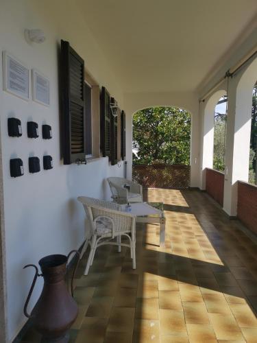 a room with a table and chairs on a floor at Villa Flora Affittacamere in Luni