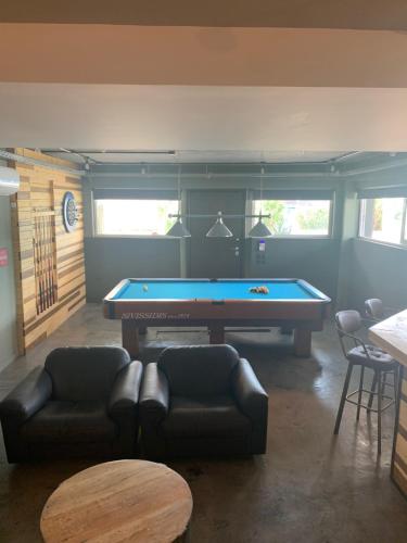 a living room with a pool table and couches at Unique space in Gerakas - Cave in Athens