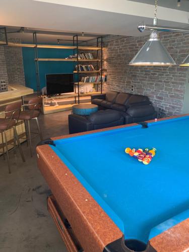 a pool table in a living room with a couch at Unique space in Gerakas - Cave in Athens