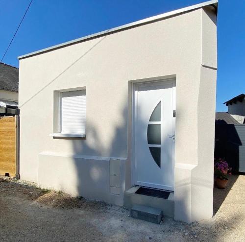 une maison blanche avec une porte blanche et une fenêtre dans l'établissement maison moderne proche centre ville/hôpital, à Angers