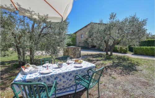 a table with a blue and white table cloth and chairs at Villa San Venanzo in Baccano