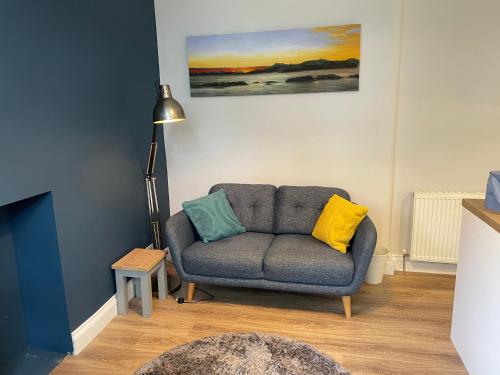 a living room with a couch and a lamp at Central Helensburgh 1 BR, gr floor pet friendly in Helensburgh