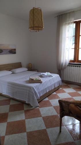 a bedroom with a bed and a checkered floor at La Casa Dell'Arco in Carasco