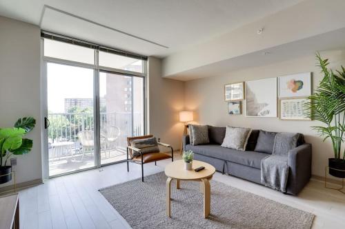 a living room with a couch and a table at Exclusive Condo With Stunning Views at Crystal City in Arlington