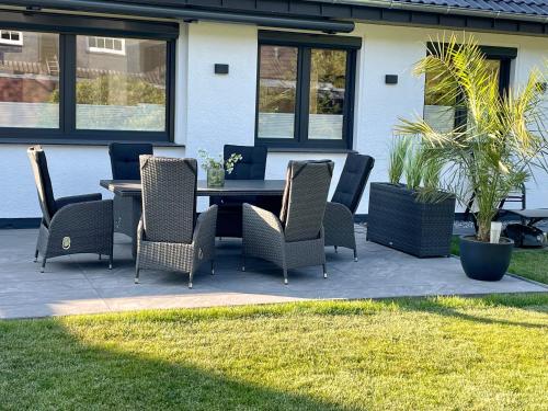 a table and chairs sitting on a patio at Wellnesshome Fontaneweg mit Sauna, Terrasse und Garten in Espelkamp