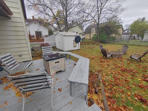 a backyard with a table and chairs and a grill at Huge historic, w/large yard & close to beach in Manistee