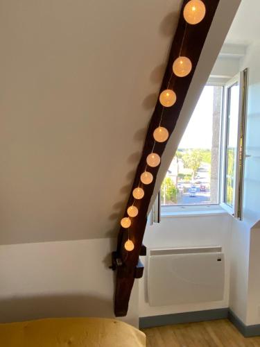 a staircase with lights on the side of a room at Studio Cocooning in Saint-Samson-sur-Rance