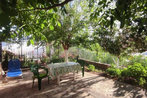 a table and chairs sitting under a tree at Potami Studios in Lefkímmi