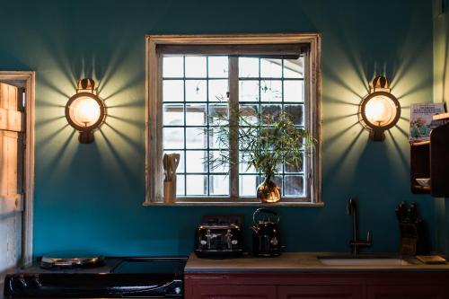 a kitchen with a window and a counter with a sink at St Giles House Accommodation in Wimborne Saint Giles