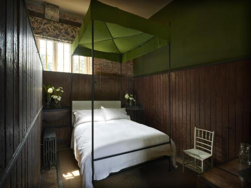a bedroom with a bed with a canopy at St Giles House Accommodation in Wimborne Saint Giles