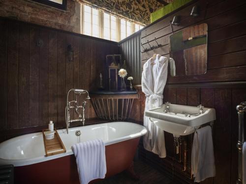 a bathroom with a tub and a sink at St Giles House Accommodation in Wimborne Saint Giles