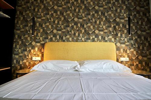 a bedroom with a white bed with a head board at Le Cupole Design in Palermo