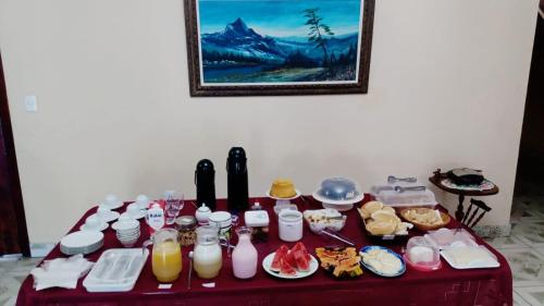 Ein Tisch mit einem Haufen Essen und Getränken drauf. in der Unterkunft Pousada Soul Green in Paraty