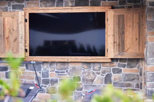 a wooden window on a stone wall at Sunshine Apartment Spirit of Deer in Garmisch-Partenkirchen