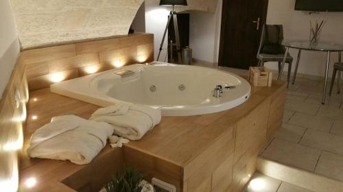 a bathroom with a bath tub with towels on the floor at Palazzo Kapece in Monopoli