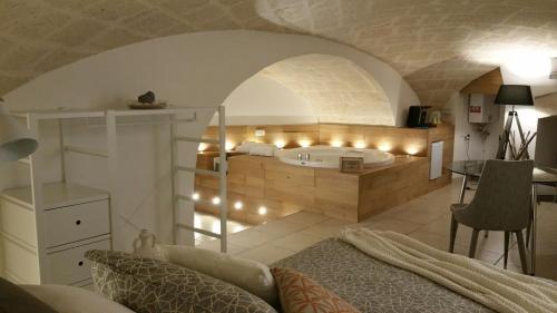 a bedroom with a bed and a room with lights at Palazzo Kapece in Monopoli