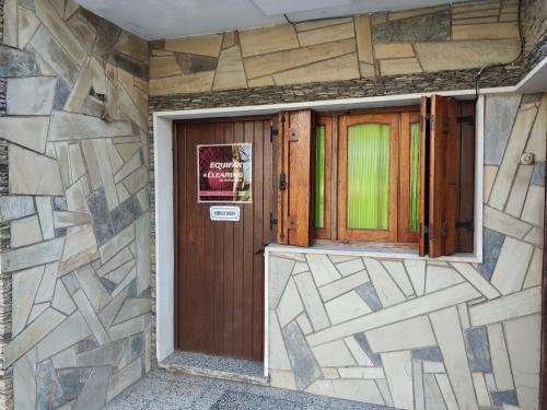 a front door of a house with a sign on it at Suculento Apart in Fray Bentos