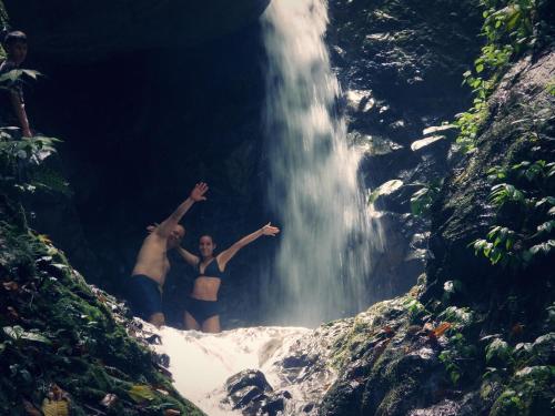 two men standing in front of a waterfall at Finca TRADICIONAL EL OTOÑO in Pijao