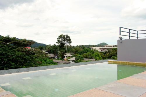 an infinity pool on the roof of a house at Cheeky Monkey's Samui in Chaweng