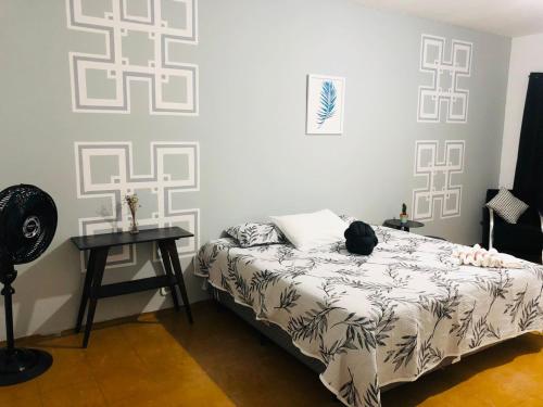 a bedroom with a bed and a table in it at Hotel Nobre Requinte in Arujá